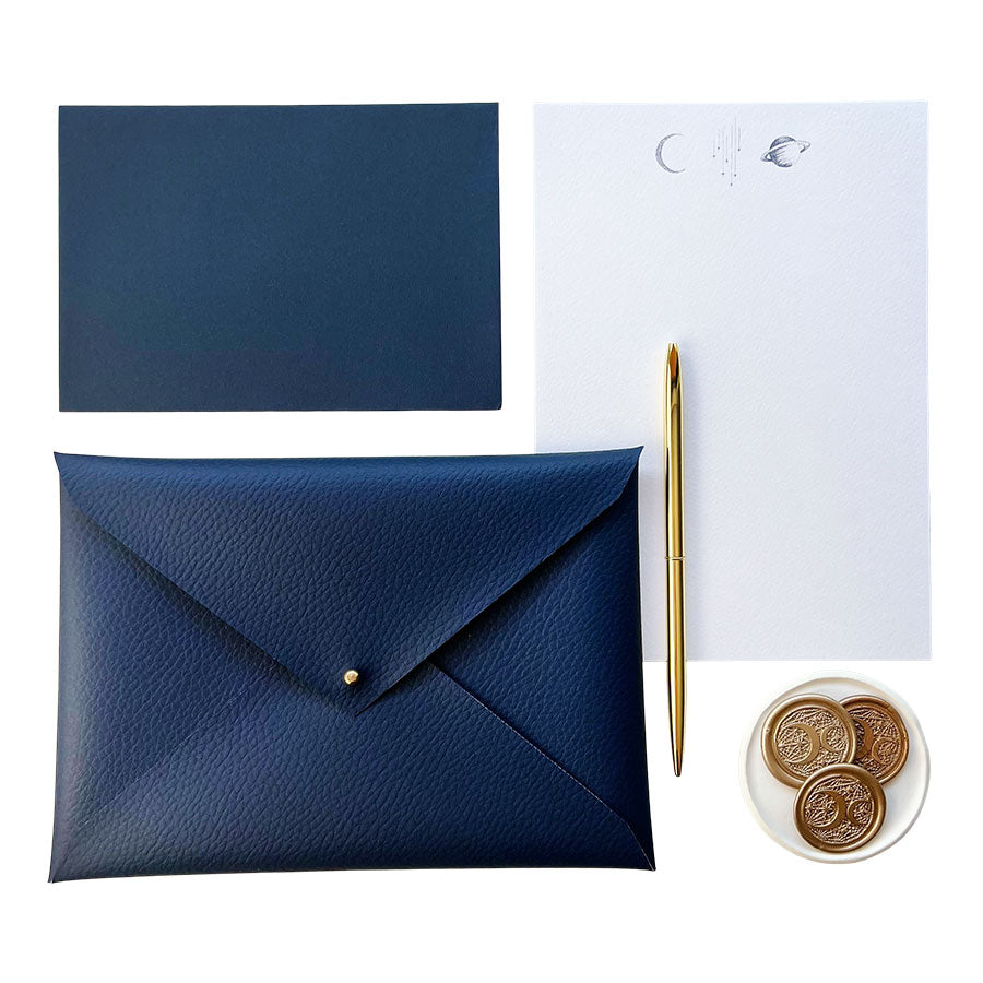 Luxury space writing set, handmade navy faux-leather envelope pouch and hand illustrated writing paper and envelopes. The Stargazer Collection Writing Set - a premium themed gift.