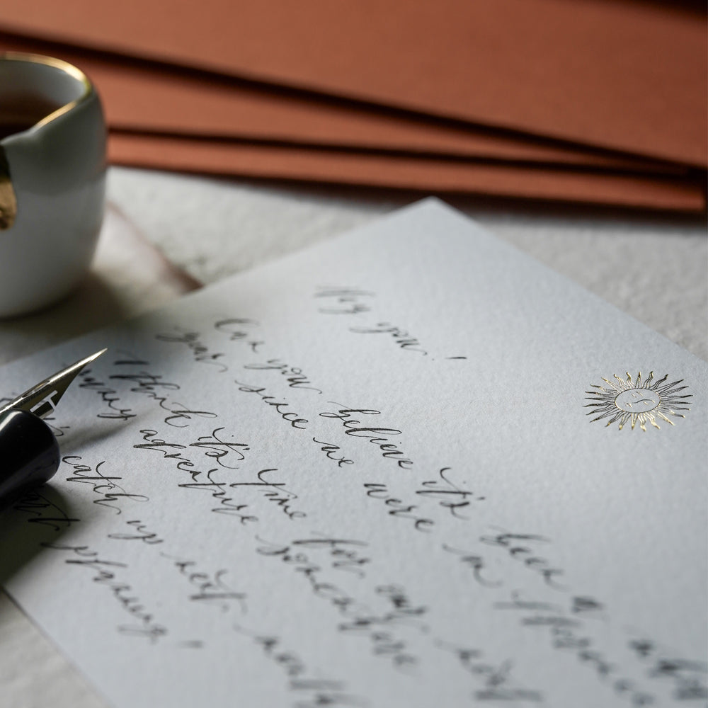 
                      
                        Enjoy taking a little time to yourself to write with one of our gold foiled sun notecards,& individually hand pressed using a traditional hot foil embossing method in our Cambridge studio.
                      
                    