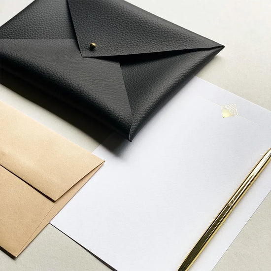An elegant Art Deco writing set, presented in a handmade faux-leather envelope pouch.