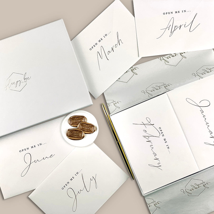 
                      
                        Year of letters box, a unique keepsake gift with luxury writing paper, envelopes, & gold foil stickers for you to write 12 letters.
                      
                    